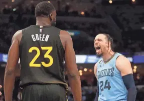  ?? STU BOYD II/THE COMMERCIAL APPEAL ?? Memphis forward Dillon Brooks (24) reacts after teammate Jaren Jackson Jr. scored and drew a foul against Golden State forward Draymond Green (23) at the Fedex Forum on Saturday in Memphis.