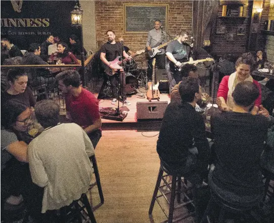  ?? ALLEN MCINNIS ?? Jam Avenue warms up the room at McKibbins Irish Pub’s St-Laurent Blvd. location. “We do it because it’s fun,” vocalist and guitar player Sergio Spiezia said during a break at another recent McKibbins gig. “I was cursing like a sailor looking for...