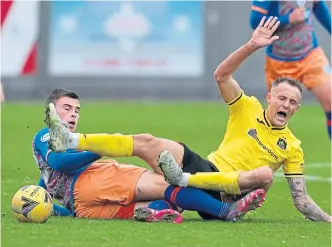  ?? ?? Queen’s Park’s Jack Thomson (left) tackles Dumbarton’s Ross Maclean