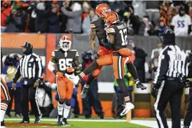  ?? RON SCHWANE / ASSOCIATED PRESS ?? Cleveland Browns’ Donovan Peoples-jones, center left, celebrates his touchdown with Michael Woods II during the second half of the Browns’ game against the Baltimore Ravens in Cleveland, on Saturday.