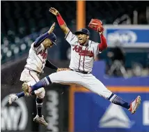  ?? ELSA / GETTY IMAGES ?? Braves second baseman Ozzie Albies (left) and outfielder Ronald Acuna celebrate after beating the Mets on Tuesday. Since becoming the leadoff hitter after the All-Star break, Acuna has hit .316 with 19 home runs, 41 RBIs, 53 runs and 14 stolen bases.