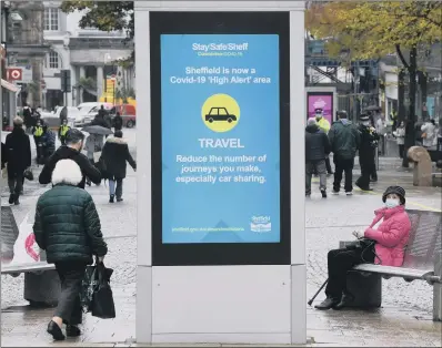  ?? PICTURE: JONATHAN GAWTHORPE ?? RESTRICTIO­NS: Shoppers wearing face masks in Sheffield city centre.