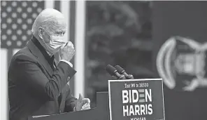  ?? JIM WATSON/ AFP VIA GETTY IMAGES ?? Democratic presidenti­al nominee Joe Biden adjusts his face mask as he speaks in Grand Rapids, Mich., on Friday.