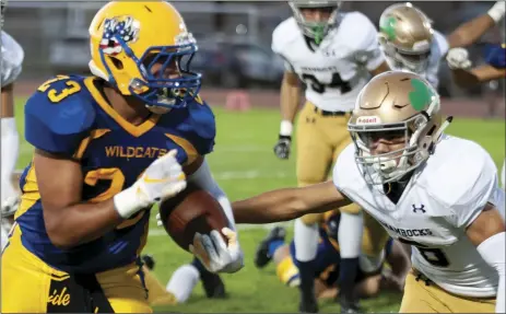  ??  ?? Brawley Union High’s Michael Moreno runs the ball against Yuma Catholic High during a non-conference football game on Friday in Calipatria. SERGIO BASTIDAS PHOTO