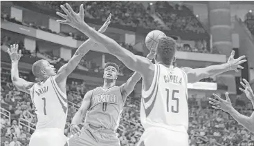  ?? Mark Milligan / Houston Chronicle ?? The Rockets’ Trevor Ariza, left, and Clint Capela cut off Nuggets guard Emmanuel Mudiay, but the 19-yearold rookie showed his great promise with a 17-point, nine-assist NBA debut.