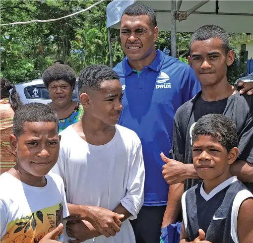  ?? Photo: Waisea Nasokia ?? Swire Shipping Fijian Drua squad member Michael Naitokani (wearing blue shirt), with fans in Ba on December 3, 2022.