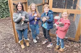  ?? TERRY CHEA/AP ?? Members of the Abta family — Allison, from left, Violet, Eli and Ariella — hold hens in front of their backyard chicken coop in Ross, California.