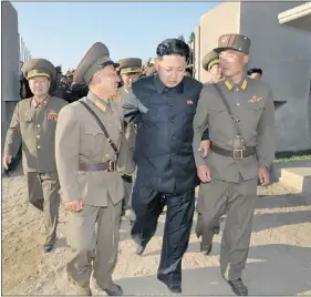  ?? — GETTY IMAGES ?? North Korean leader Kim Jong Un, centre, inspects the Wolnae Island Defence Detachment on Wednesday.