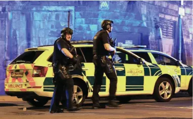  ?? PICTURE: PETER BYRNE/PA WIRE ?? EMERGENCY: Armed police at Manchester Arena after a bombing at the venue after an Ariana Grande gig.