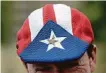  ?? Carlos Giusti / Associated Press ?? Paul McQue of Scotland wears a Puerto Rican hat with a Hamilton pin in San Juan.