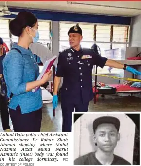  ?? COURTESY OF POLICE PIX ?? Lahad Datu police chief Assistant Commission­er Dr Rohan Shah Ahmad showing where Muhd Nazmie Aizat Muhd Narul Azman’s (inset) body was found in his college dormitory.