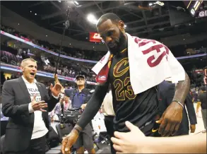  ?? Gregory Shamus / Getty Images ?? LeBron James walks off the court after defeating the Boston Celtics during Game 6 of the Eastern Conference Finals on Friday in Cleveland.