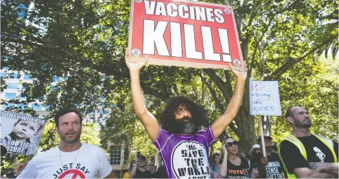  ?? BROOK MITCHELL / GETTY IMAGES FILES ?? Protesters make their feelings known at an anti-vaccinatio­n rally in February in Sydney, Australia.