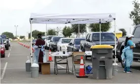  ?? Photograph: Delcia Lopez/AP ?? Health officials and members of the military assist in Covid-19 testing in Texas. In San Antonio, a patient died after attending a ‘Covid party’.