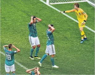  ?? LUIS ACOSTA/AFP/GETTY IMAGES ?? German players lift their hands to their heads in unison during a game against South Korea. Failures and mistakes on the soccer pitch prompt a near-uniform response.