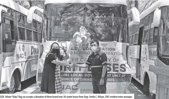  ??  ?? GOV. Arlene “Kaka” Bag-ao accepts a donation of three brand new 30-seater buses from Engr. Arnilo C. Milaor, CMC resident mine manager.