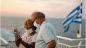  ??  ?? Passengers are seen wearing masks on the deck of a ferryboat. An increasing number of people are reacting to restrictio­ns imposed to curb the coronaviru­s.