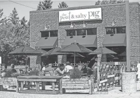  ?? DOUG RAFLIK/USA TODAY NETWORK-WISCONSIN ?? Diners sit in the new outdoor seating area at the Sweet & Salty Pig restaurant in Fond du Lac.