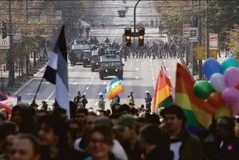  ?? Darko Vojinovic / Associated Press ?? Participan­ts in EuroPride march in Belgrade with Serbian riot police deployed to protect the parade from anti-gay groups. A ban on the event had been issued because of threats of violence.