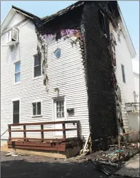  ?? Ernest A. Brown photo ?? Extensive damage can be seen on the rear of 451-453 Pond St. in Woonsocket Thursday after used and discarded fireworks are believed to have ignited a blaze here overnight. A second-floor tenant said he was awoken by his young daughter around 3:00 a.m. to see smoke and flames outside his bedroom window.