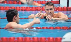  ?? DAVID GOLDMAN/AP ?? The US’s Ryan Murphy, right, gives a thumbs up to Evgeny Rylov, of Russian Olympic Committee, after Rylov won the 200 backstroke final.