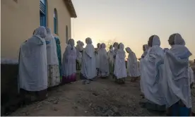  ??  ?? Orthodox Christian refugees who fled the conflict in Tigray pray at a camp in Hamdeyat near the Sudan-Ethiopia border. Photograph: Nariman El-Mofty/AP