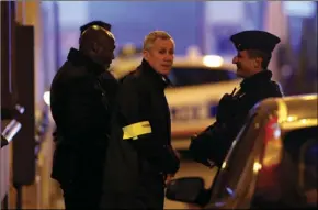  ?? AP PHOTO/THIBAULT CAMUS ?? The Paris prosecutor Francois Molins (center) speaks with police officers after delivering a speech to say counterter­rorism authoritie­s are investigat­ing after a knife attack that left at least two dead including the assailant in central Paris, on...