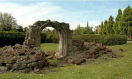  ??  ?? A medieval arch standing alone in the ruins of the Friary wall frames a view of the garden.