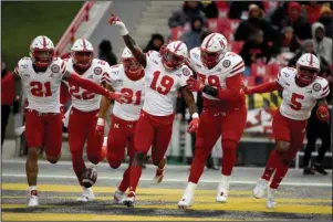  ?? The Associated Press ?? TESTING COSTLY: Nebraska safety Marquel Dismuke (19) celebrates with teammates after recovering a fumble from Maryland running back Javon Leake (20) during the first half of a Nov. 23, 2019 NCAA football game in College Park, Md. Nebraska’s 24-sport program has about 600 athletes and is one of a handful that makes money. Though a 10% budget cut was announced recently, the program is able to absorb the cost of coronaviru­s testing, in part because of its affiliatio­n with the university’s medical school.