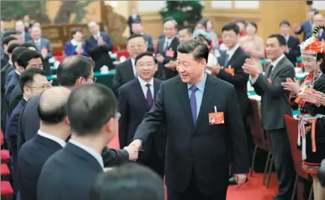  ?? JU PENG / XINHUA ?? President Xi Jinping attends discussion­s with National People’s Congress deputies from Fujian province in Beijing on Sunday.