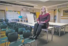  ?? GABRIELA CAMPOS/THE NEW MEXICAN ?? Alyssa Maestas, mother of two and a first grade teacher at Amy Biehl Community School, sits Thursday afternoon among empty desks and chairs in her classroom.