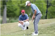  ?? — AFP ?? Kevin Kisner and Scott Brown line up a putt on the eighth hole.