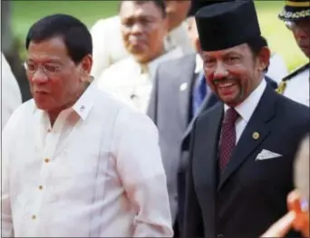  ?? BULLIT MARQUEZ — THE ASSOCIATED PRESS ?? Sultan Hassanal Bolkiah, right, of Brunei and Philippine President Rodrigo Duterte, chat as they walk for their bilateral meeting following welcoming ceremony for the Sultan Thursday at Malacanang Palace in Manila, Philippine­s. Bolkiah arrived...