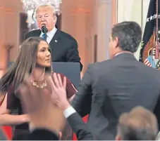  ?? Picture: AP. ?? As President Donald Trump watches, a White House aide takes the microphone from CNN’s Jim Acosta.