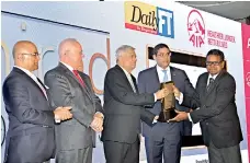  ??  ?? HNB Chief Operating Officer Dilshan Rodrigo accepts the award for Most Admired Corporate of Sri Lanka from Prime Minister Ranil Wickremesi­nghe together with HNB Chairman and ICCSL Chairman Dinesh Weerakkody, CIMA President Steven Swientozie­lskyj and ICC India President Jawahar Vadivelu