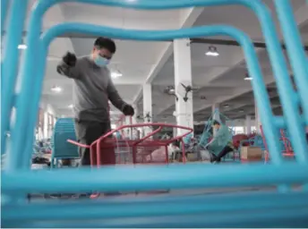  ??  ?? Workers of an export-oriented furniture company in Zhuji, Zhejiang Province in east China, make chairs on March 31. Due to the impact of the epidemic, the company is exploring ways to expand sales in the domestic market