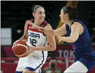  ?? ERIC GAY — THE ASSOCIATED PRESS ?? United States’ Diana Taurasi (12) drives around Serbia’s Sasa Cado (6) during the women’s basketball semifinal.