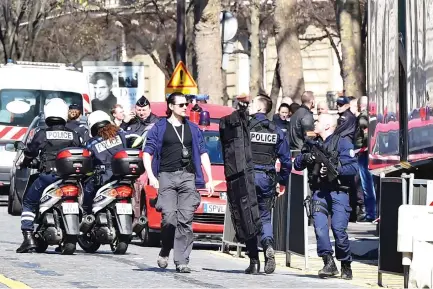  ??  ?? French police officers secure the scene near the Paris offices of the Internatio­nal Monetary Fund (IMF) after a letter bomb exploded in the premises, on Thursday. (AFP)