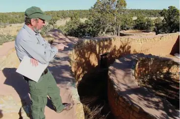  ?? Stuart Leavenwort­h / Tribune News Service ?? Tim Hovezak, an archaeolog­ist at Mesa Verde National Park, points out some of the mysterious features of the Sun Temple, which includes doorless rooms and narrow passageway­s.