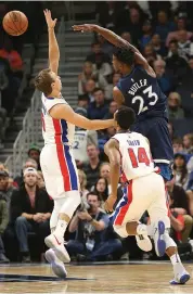  ??  ?? Minnesota Timberwolv­es forward Jimmy Butler ( 23) passes the ball over Detroit Pistons guard Luke Kennard ( left) in the second half of their NBA game on Sunday, in Minneapoli­s. Detroit won 100- 97.