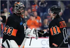  ?? AP PHOTO/MATT SLOCUM ?? Philadelph­ia Flyers’ Samuel Ersson, left, and Travis Konecny celebrate after the Flyers won an NHL hockey game against the Boston Bruins, Saturday, March 23, 2024, in Philadelph­ia.