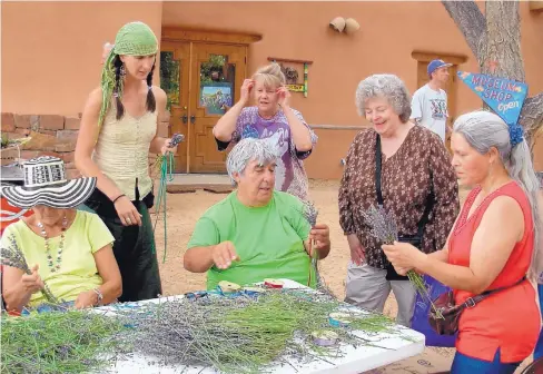  ?? COURTESY OF VIC MACIAS ?? Eventgoers take part in hands-on activities at a past Herb & Lavender Festival at El Rancho de las Golondrina­s, near Santa Fe.