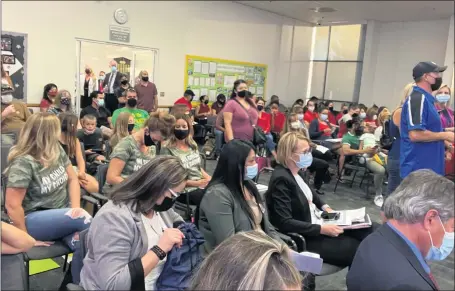  ?? PHOTO BY DAVID ALLEN ?? People come and go from a well-attended meeting of the Corona-Norco Unified school board on Aug. 3. Masks were required for entry.