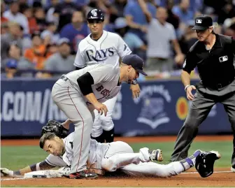  ?? AP PHOTO ?? GOTCHA! Travis Shaw tags out Tampa Bay’s Kevin Kiermaier at third base after a great throw from Mookie Betts during the eighth inning of last night’s game.