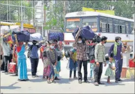  ??  ?? From left: Medical staff sanitise belongings of patients upon discharge in Dhanbad; Migrants arrive at the Amritsar railway station to board a Shramik train; Kolkata police distribute food among slum dwellers on Sunday.