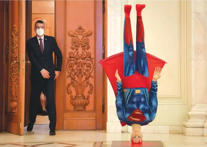  ?? ?? A mannequin depicting Superman is placed upside down next to the door of the parliament session hall hosting a no confidence vote against Romanian Prime Minister Florin Citu’s government in Bucharest, Romania, yesterday. Photo: AP