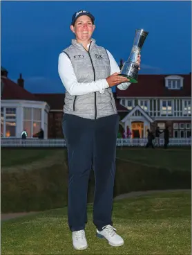  ?? ?? Darkness was already sweeping in as South Africa’s Ashleigh Buhai paraded her spoils following her Women’s Open win