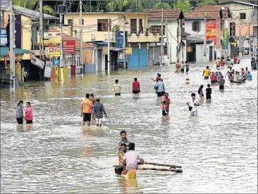  ?? Picture: AFP ?? WATER WORLD: Sri Lankan residents make their way through floodwater­s in Kaduwela at the weekend. Rainfall on Friday triggered the worst flooding and landslides in 14 years in the southern and western parts of Sri Lanka, authoritie­s said