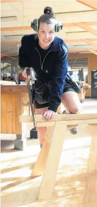  ?? PHOTO: LINDA ROBERTSON ?? She saws . . . Apprentice Kirsty Currie gets to work in the Otago Polytechni­c workshop.