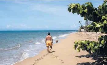 ?? ERIKA P. RODRIGUEZ/THE NEW YORK TIMES ?? A person walks on Los Almendros Beach in Rincón, Puerto Rico, on Oct. 13.